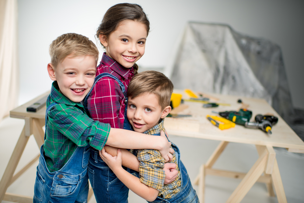 three kids hugging each other