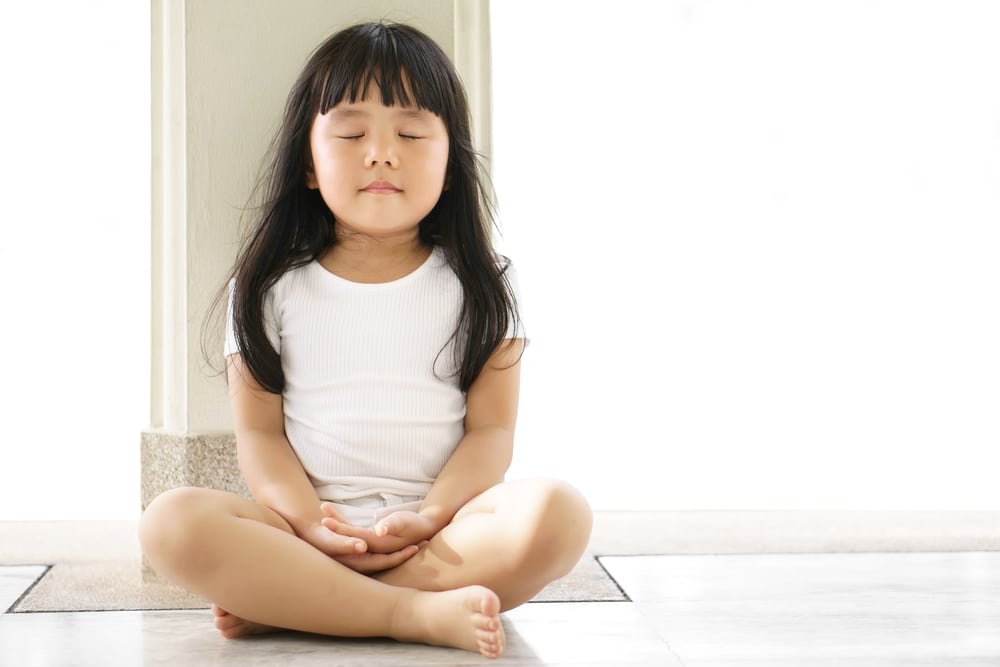 Asian children cute or kid girl sit for meditation